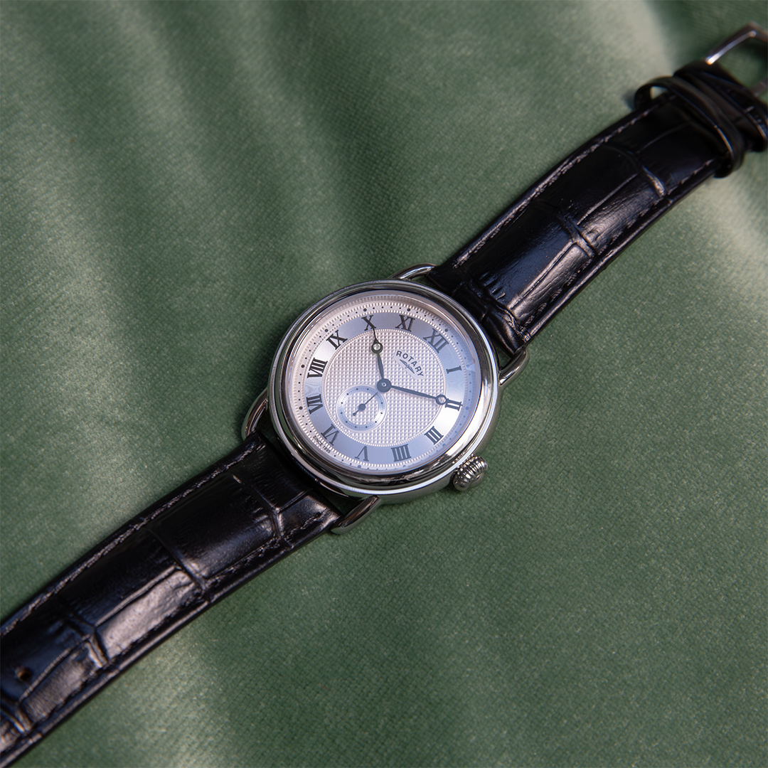 Rotary sherlock watch with a stainless steel case, a silver dial with roman numerals and a black leather strap